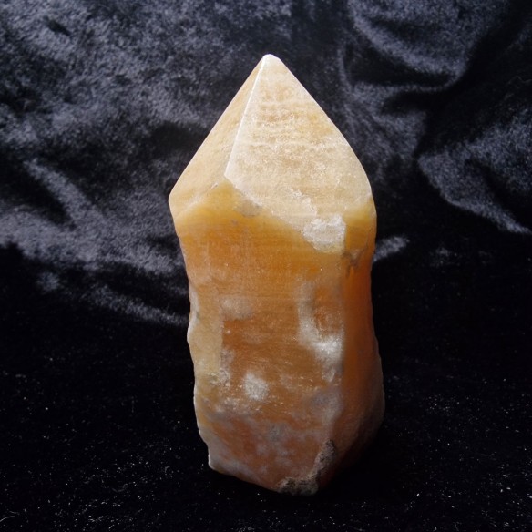 Yellow calcite polished point at Cristalljoia Barcelona