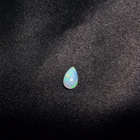 Teardrop cabochon Australian opal. The rainbow in stone.