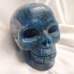 Blue apatite skull figure. The skull evokes memory