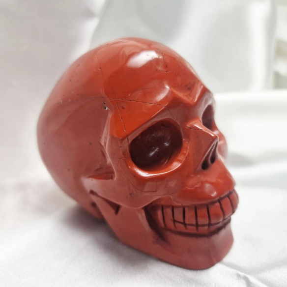 Red jasper skull figure. The skull evokes memory.