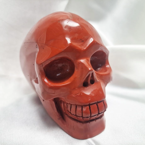 Red jasper skull figure. The skull evokes memory.