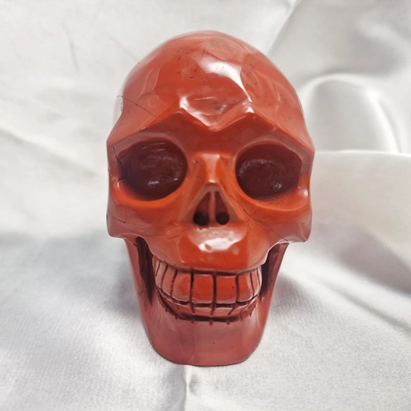 Red jasper skull figure. The skull evokes memory.