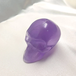 Lilac fluorite skull figurine of serene introspection