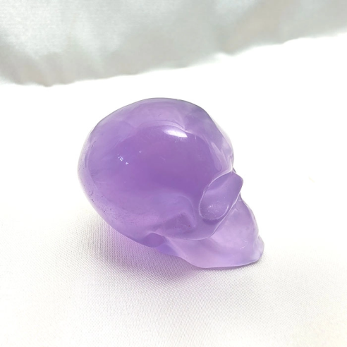 Lilac fluorite skull figurine of serene introspection