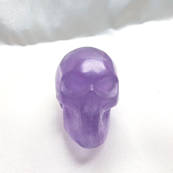 Lilac fluorite skull figurine of serene introspection
