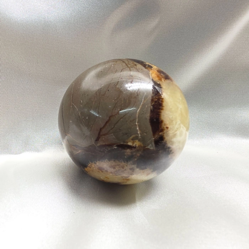 Septarian sphere. Cracks formed over time by the Earth