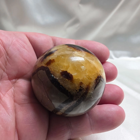 Septarian sphere. Cracks formed over time by the Earth