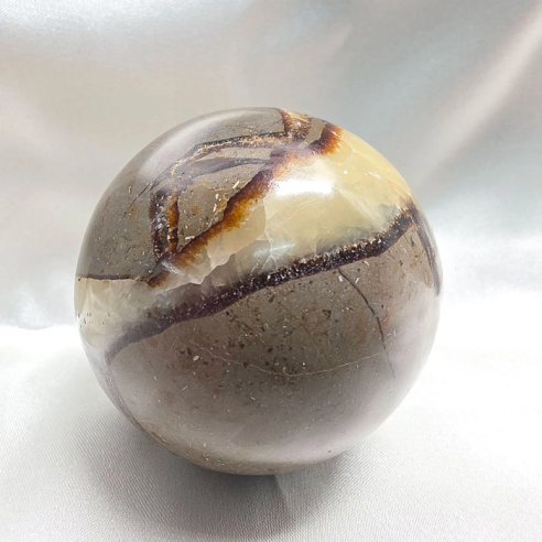 Septarian sphere. Cracks formed over time by the Earth